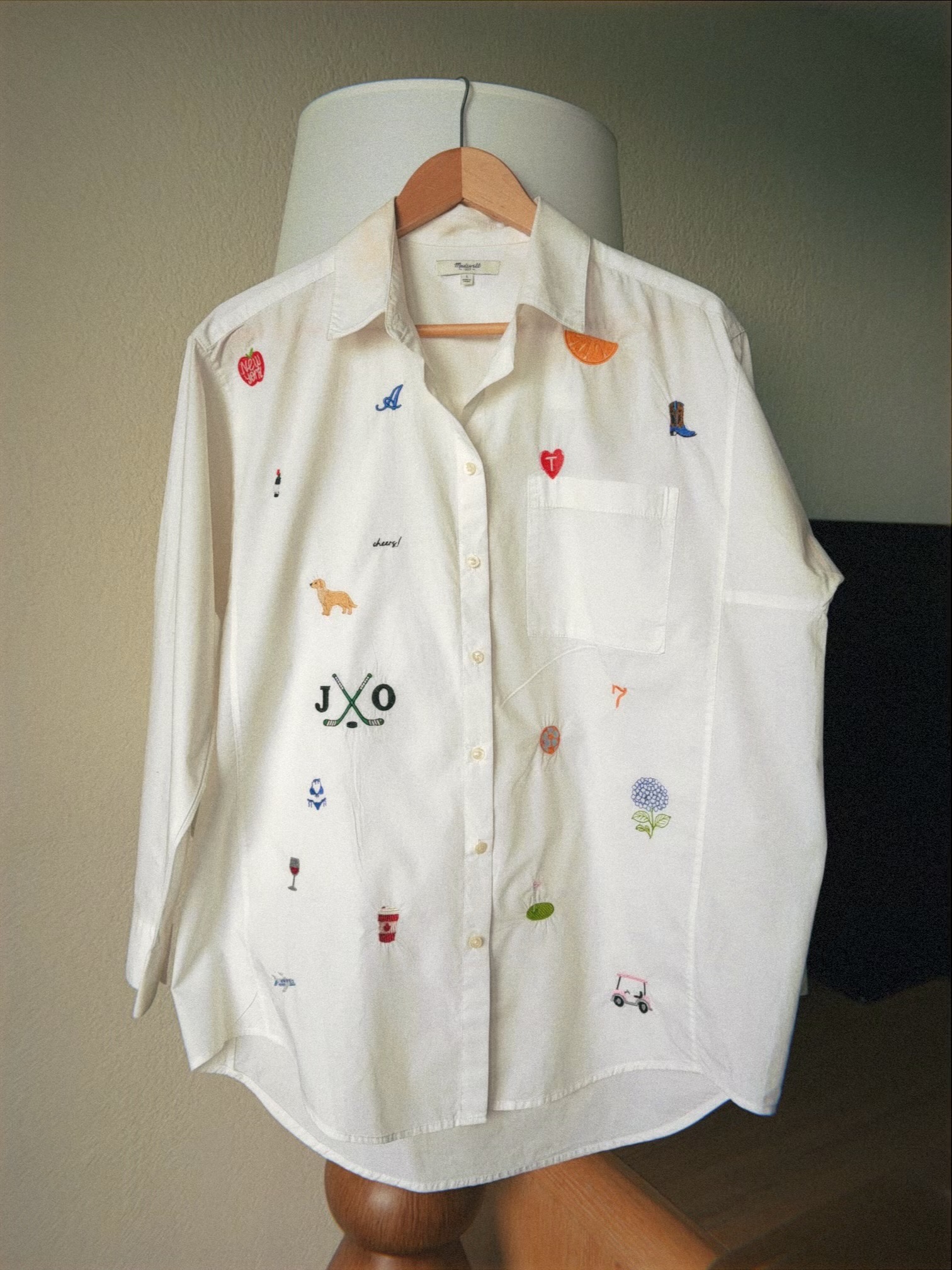 White Madewell oxford shirt covered in colorful embroidered icons and monograms